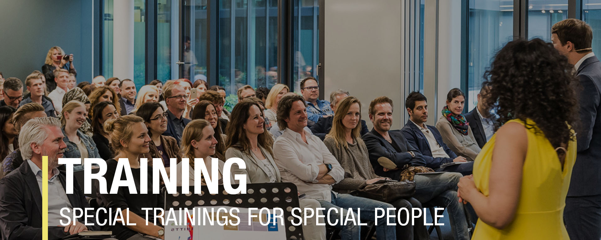Training session with engaged attendees focused on special trainings for unique individuals in a modern setting.